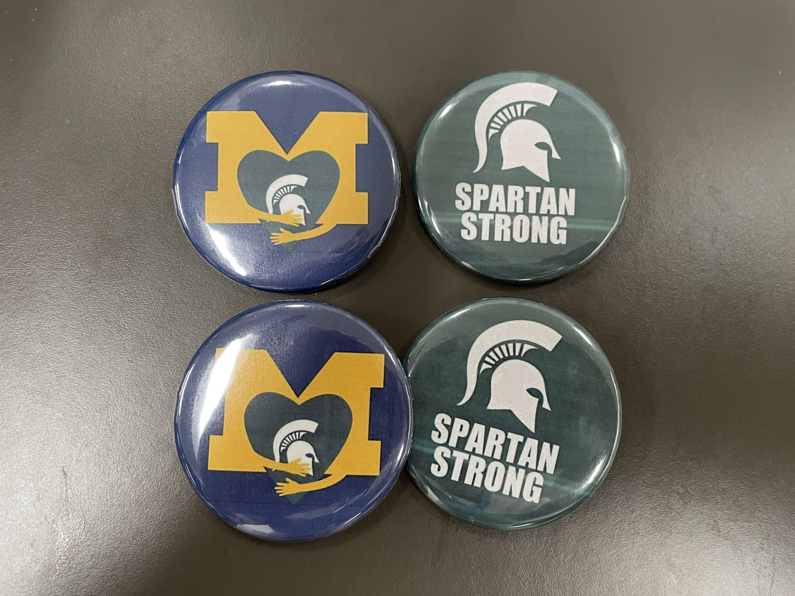U of M and Spartan Strong buttons.