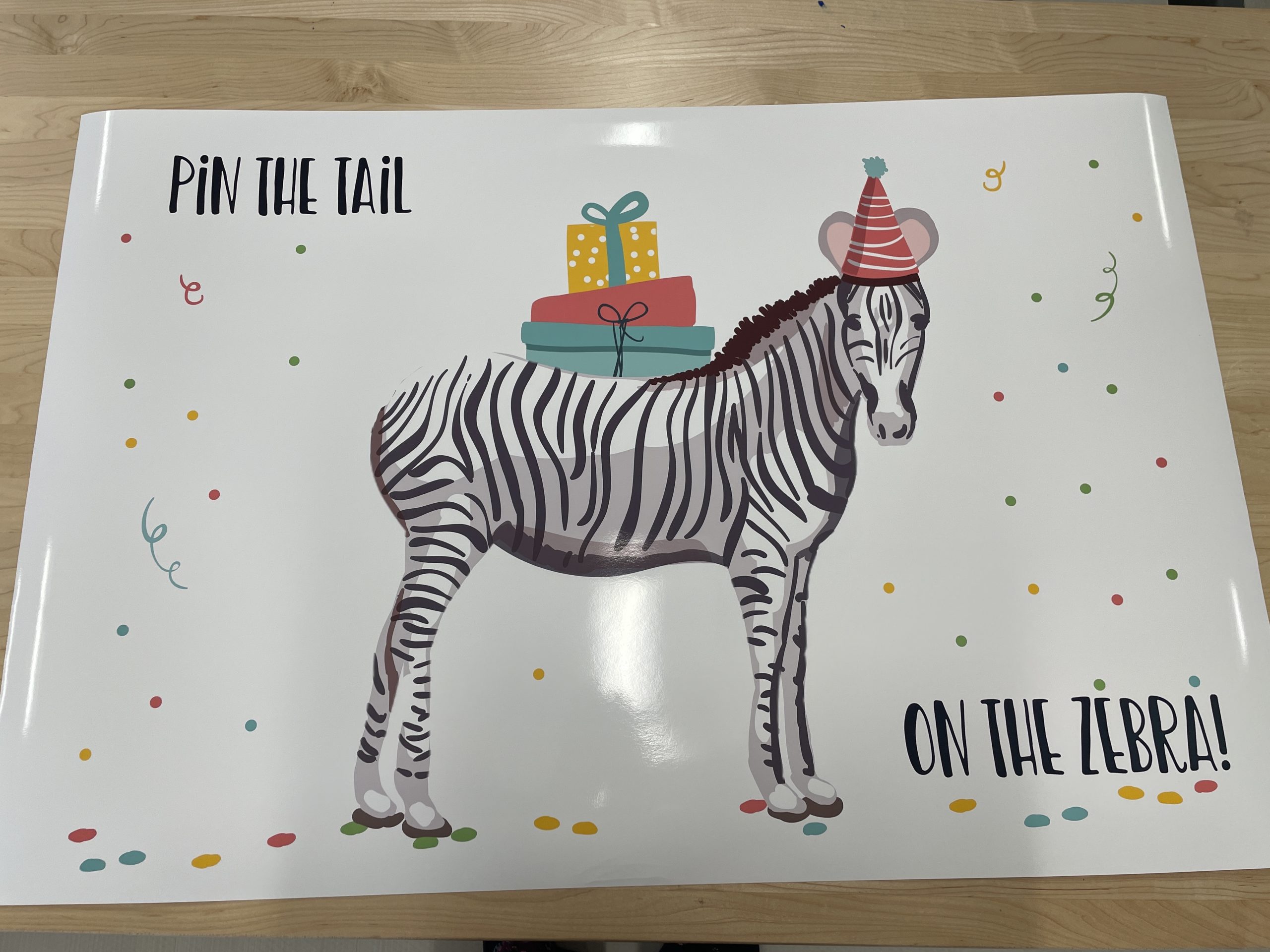 Large, printed poster of a zebra for a party game of pin the tail on the zebra.