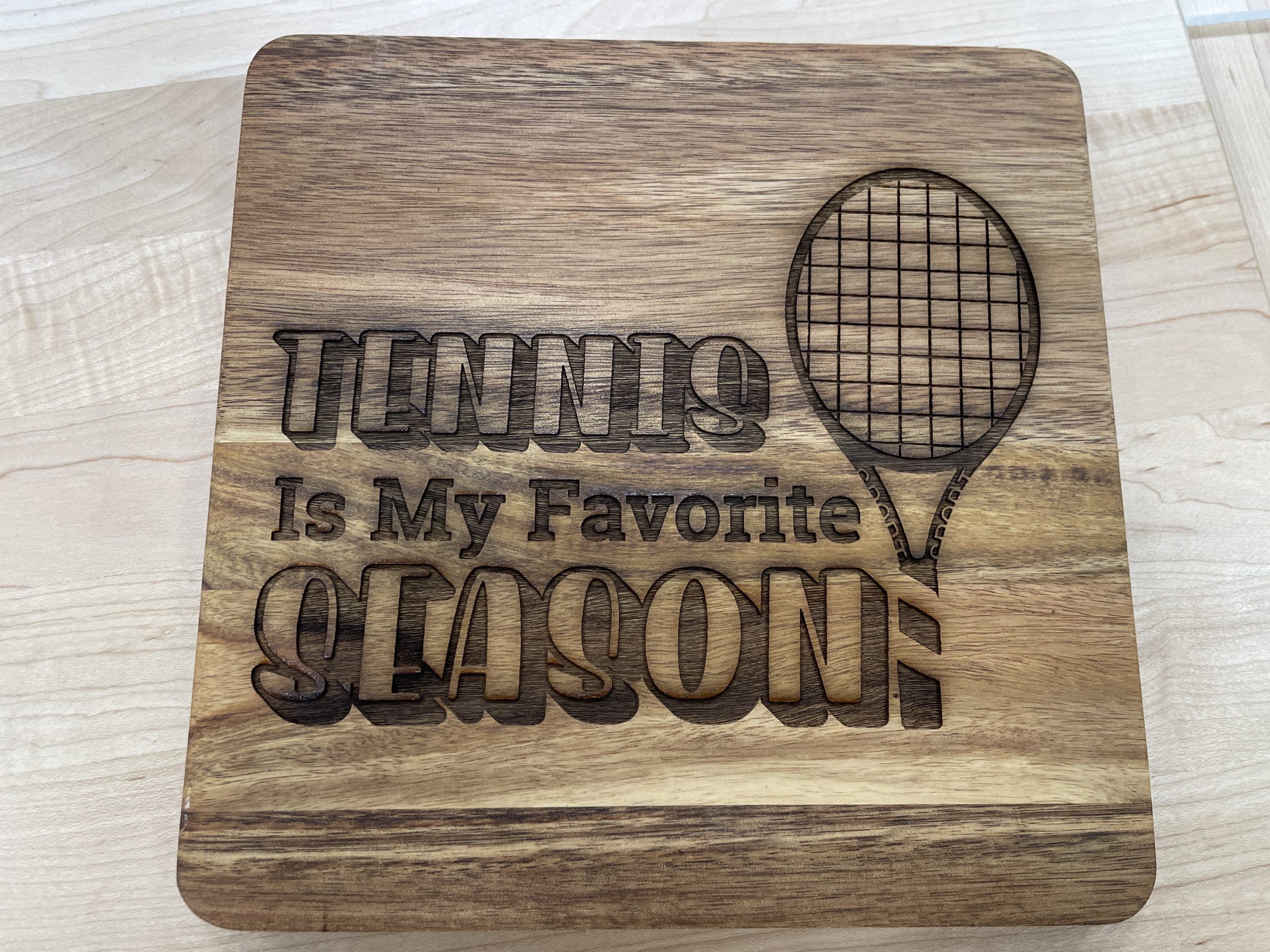 Engraved wood sign that says, " Tennis is my favorite season!"