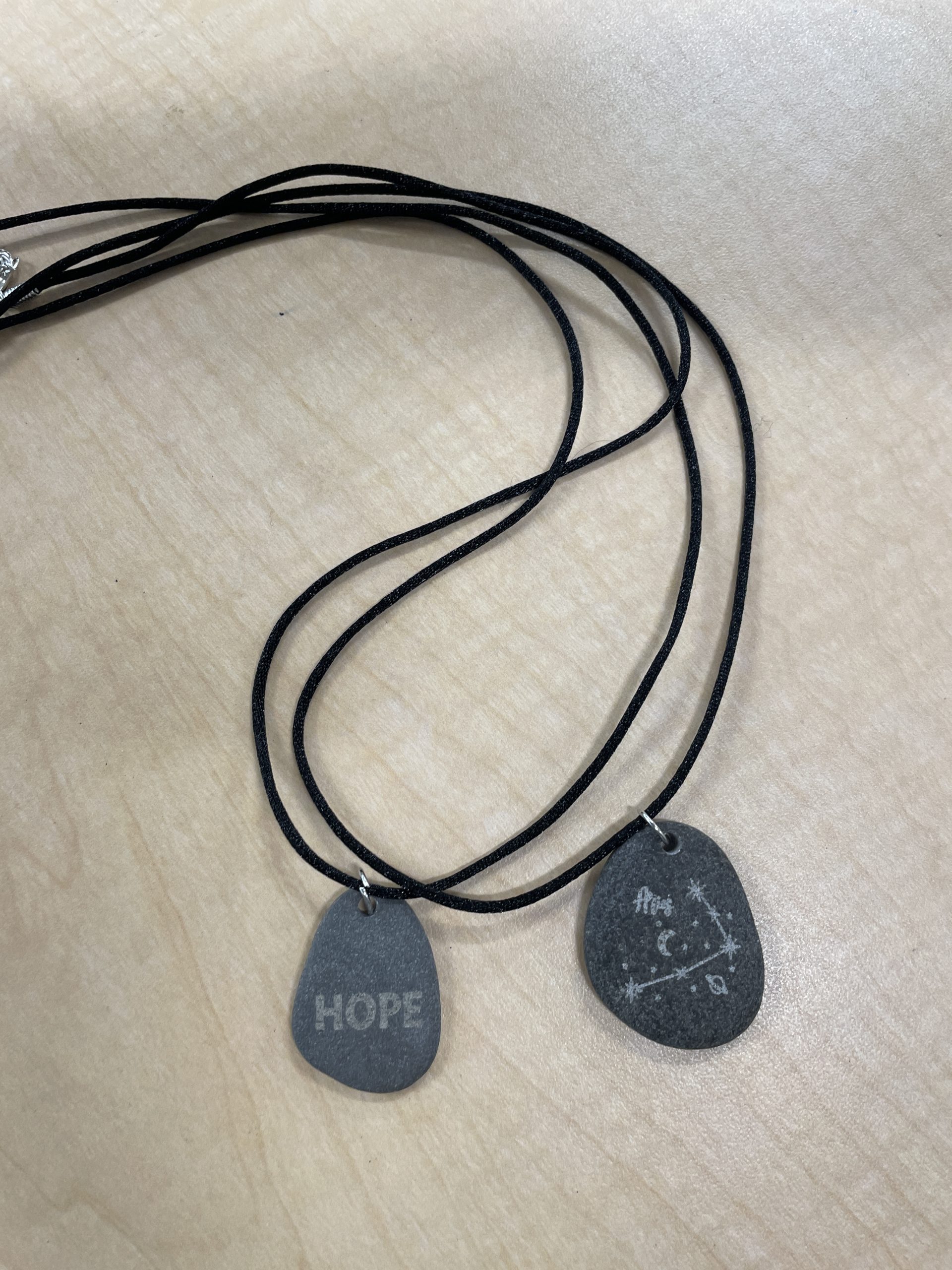 Engraved stone pendants.