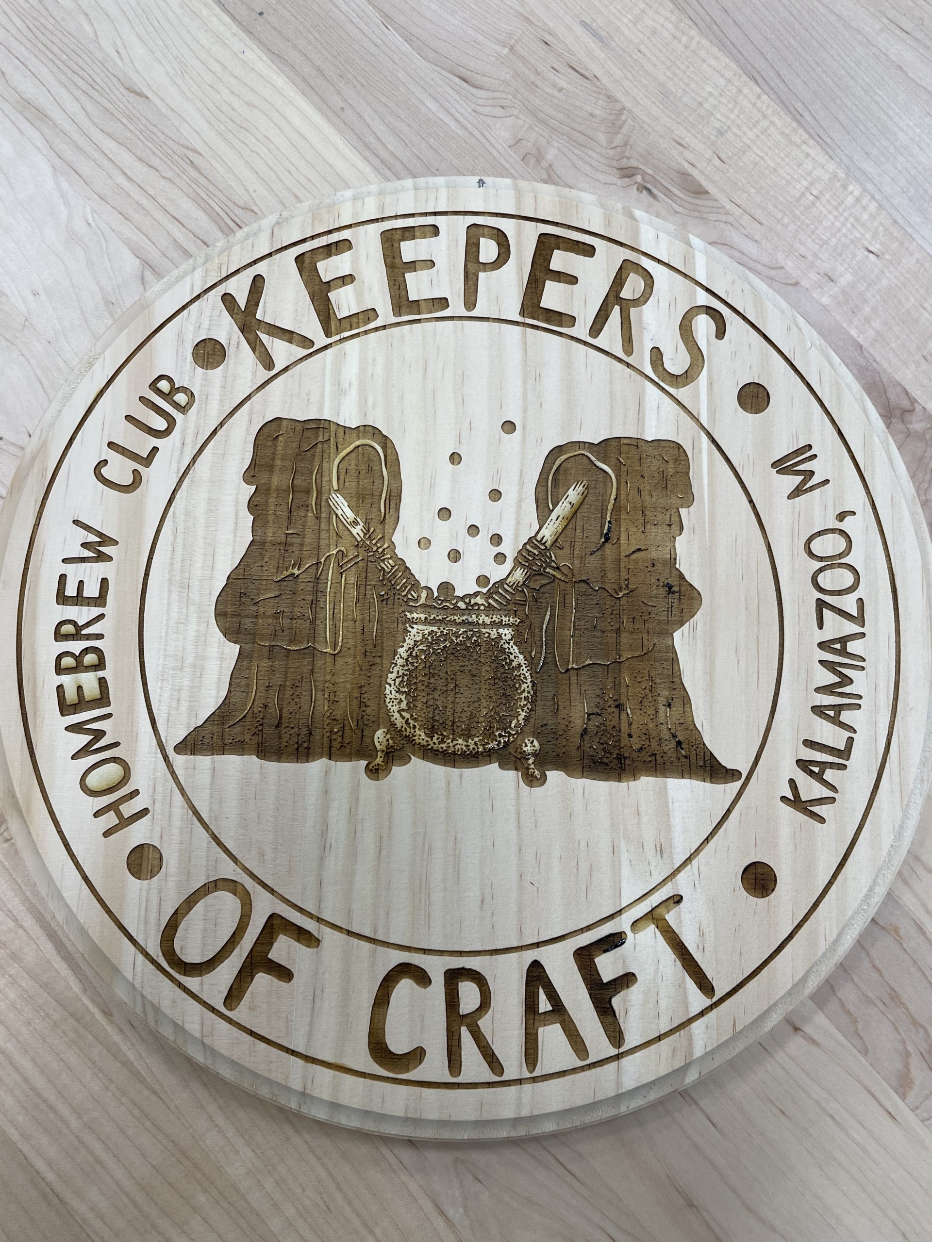 Coaster engraved with logo that says, "Homebrew Club, Kalamazoo, MI. Keepers of Craft"
