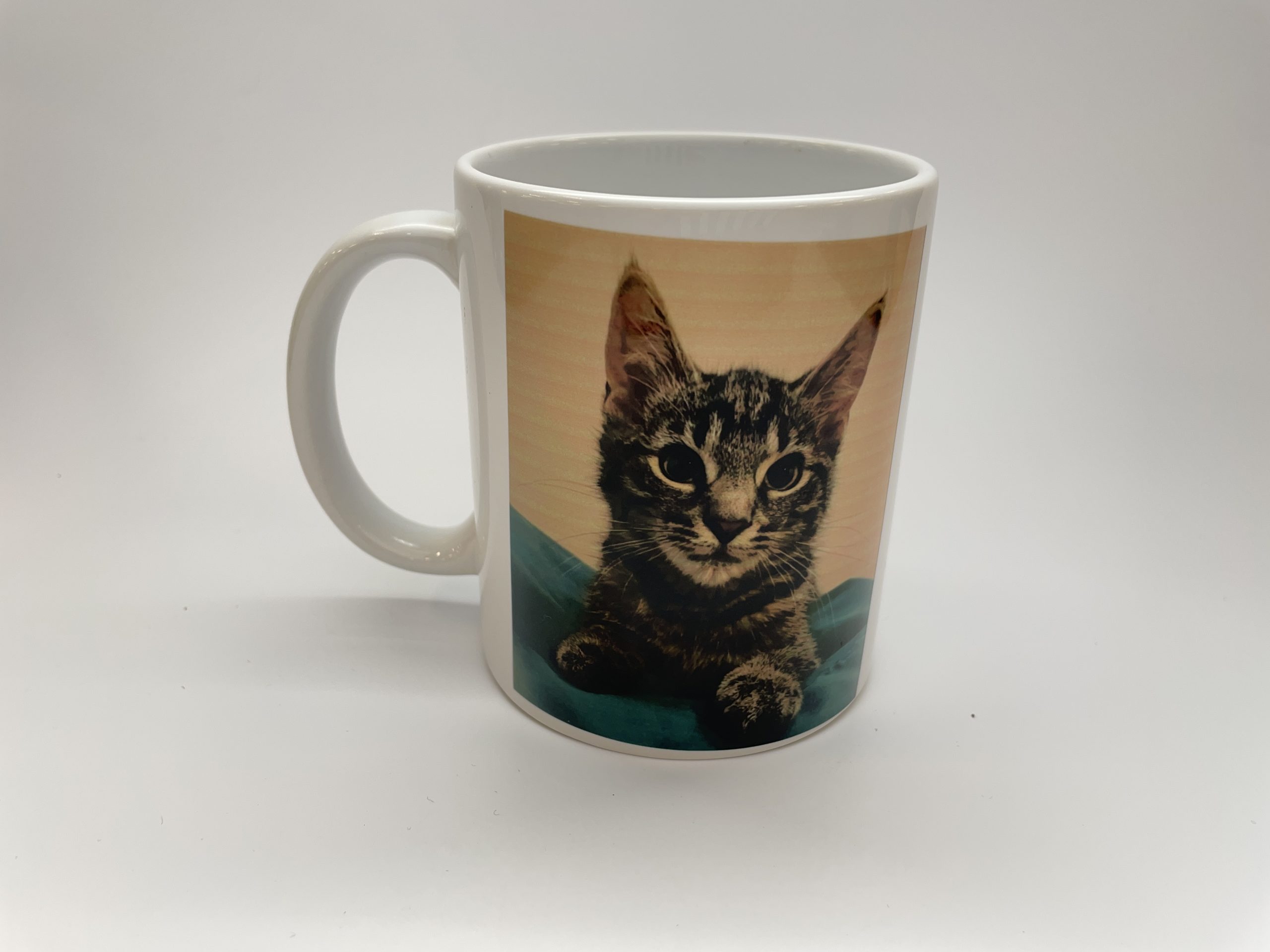 Ceramic mug with image of a gray, striped cat.